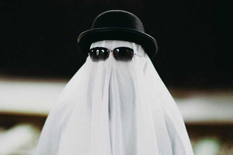 A funny depiction of a ghost wearing a black hat and sunglasses, perfect for Halloween.
